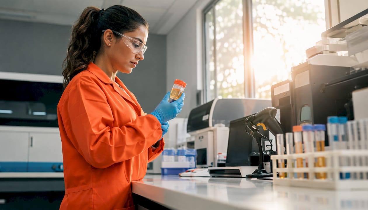 Lab technician handling urine drug test specimen