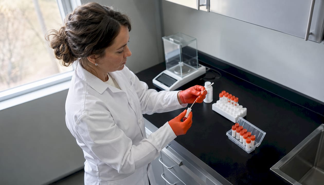 Female lab technician handling saliva drug test sample