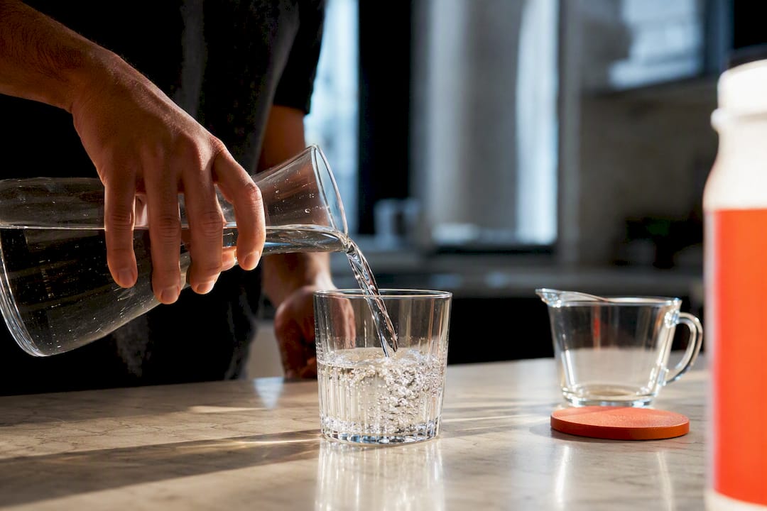 Water being poured beside an anonymous detox drink