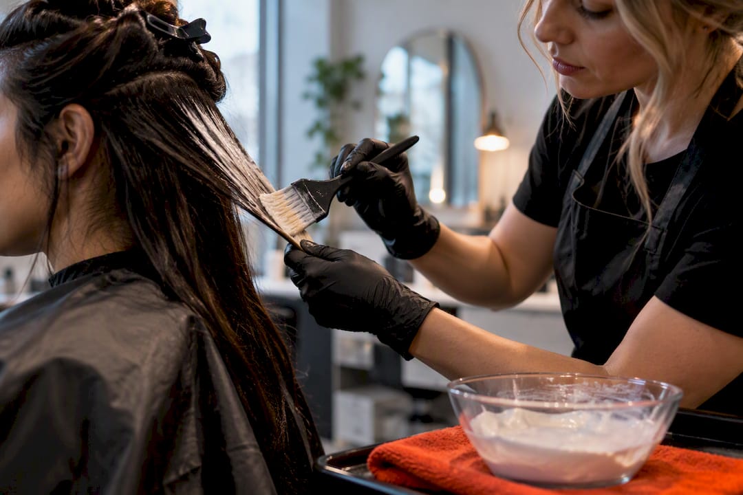 Hair being treated with bleach in salon