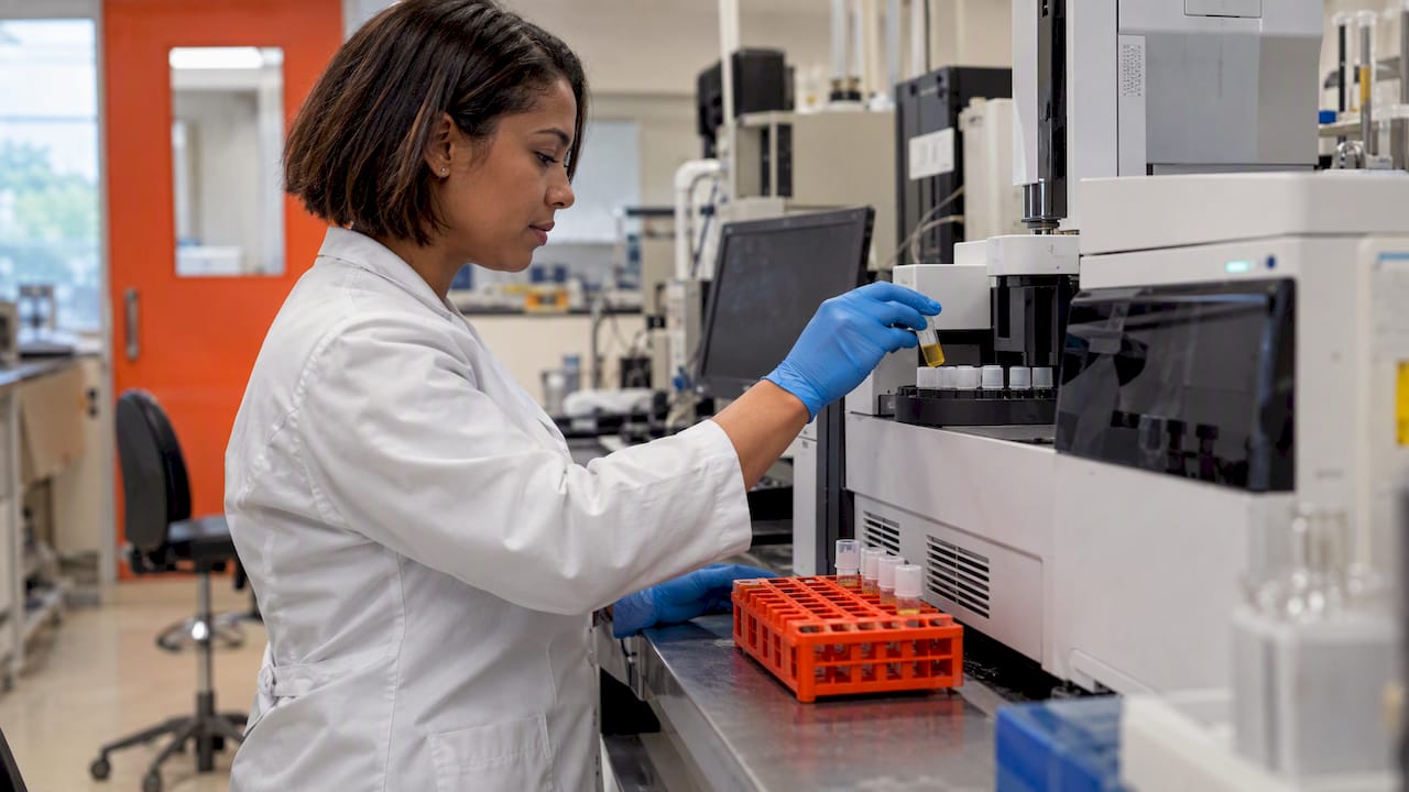 Technician preparing a urine sample for analysis